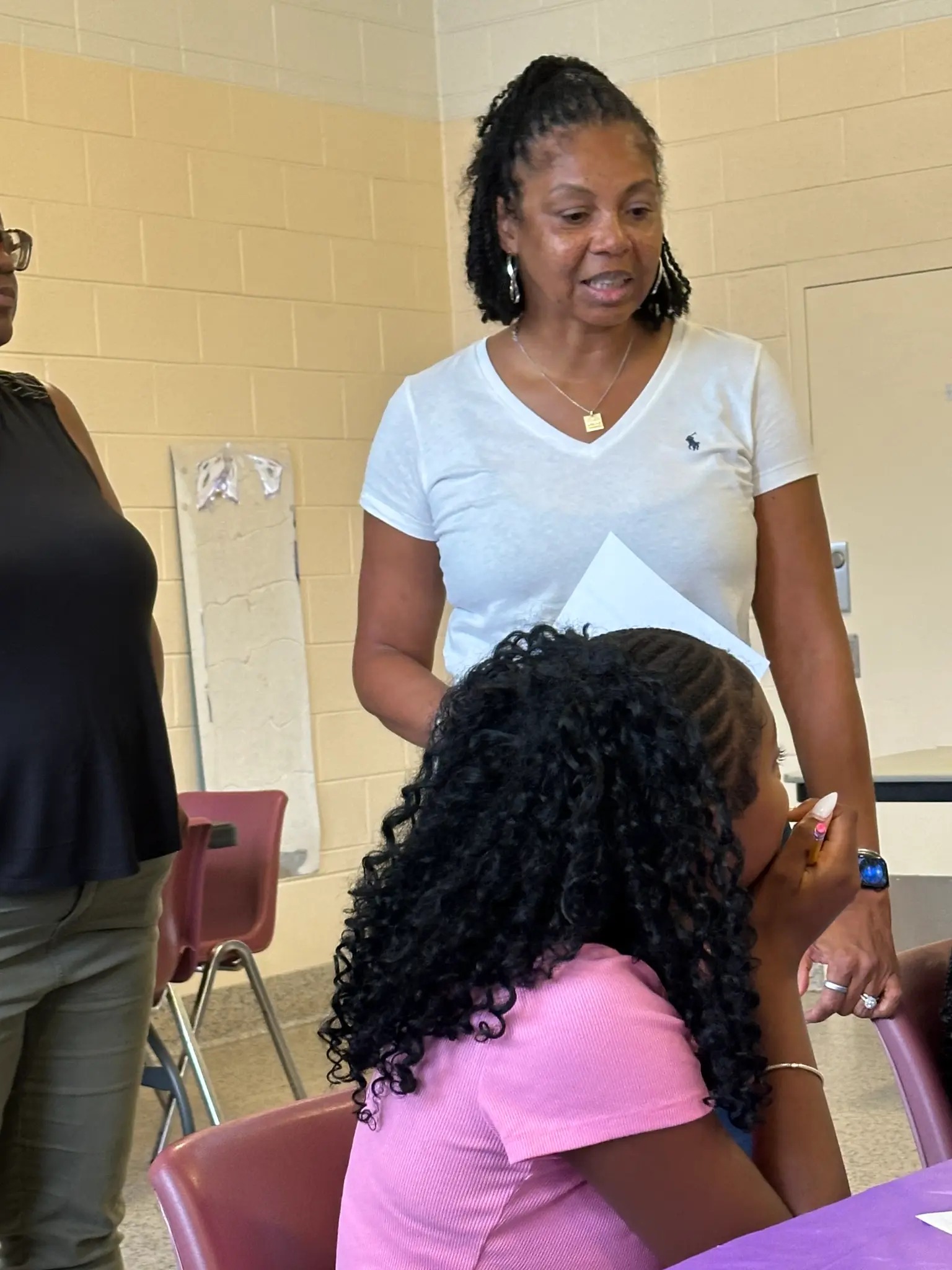 A F.I.R.E. Pathways facilitator guiding a student during a financial literacy activity